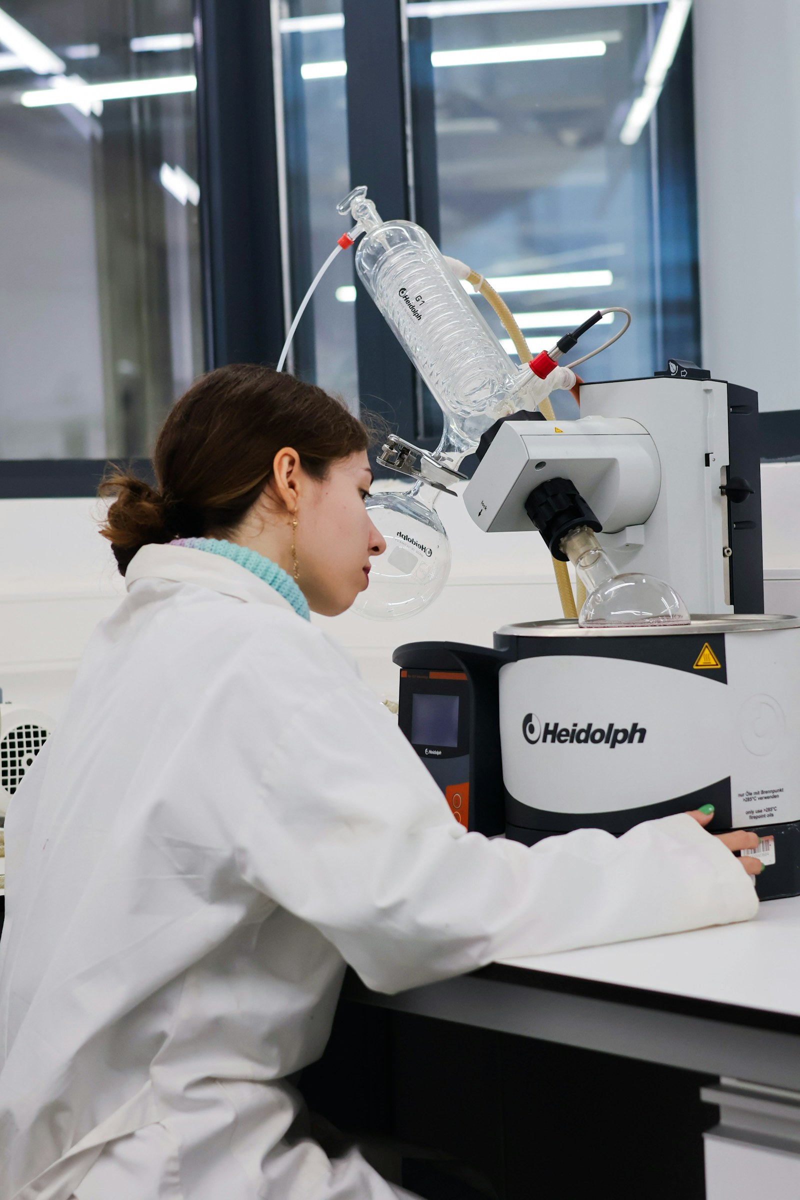 Scientist operating a rotary evaporator in a laboratory