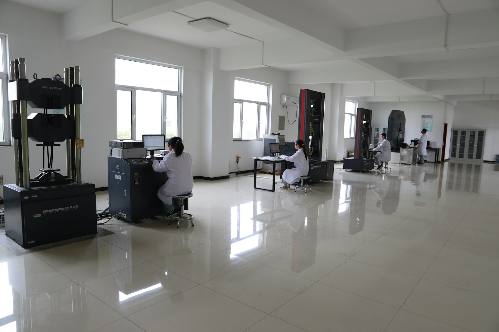 Laboratory workers operating testing equipment in a research facility
